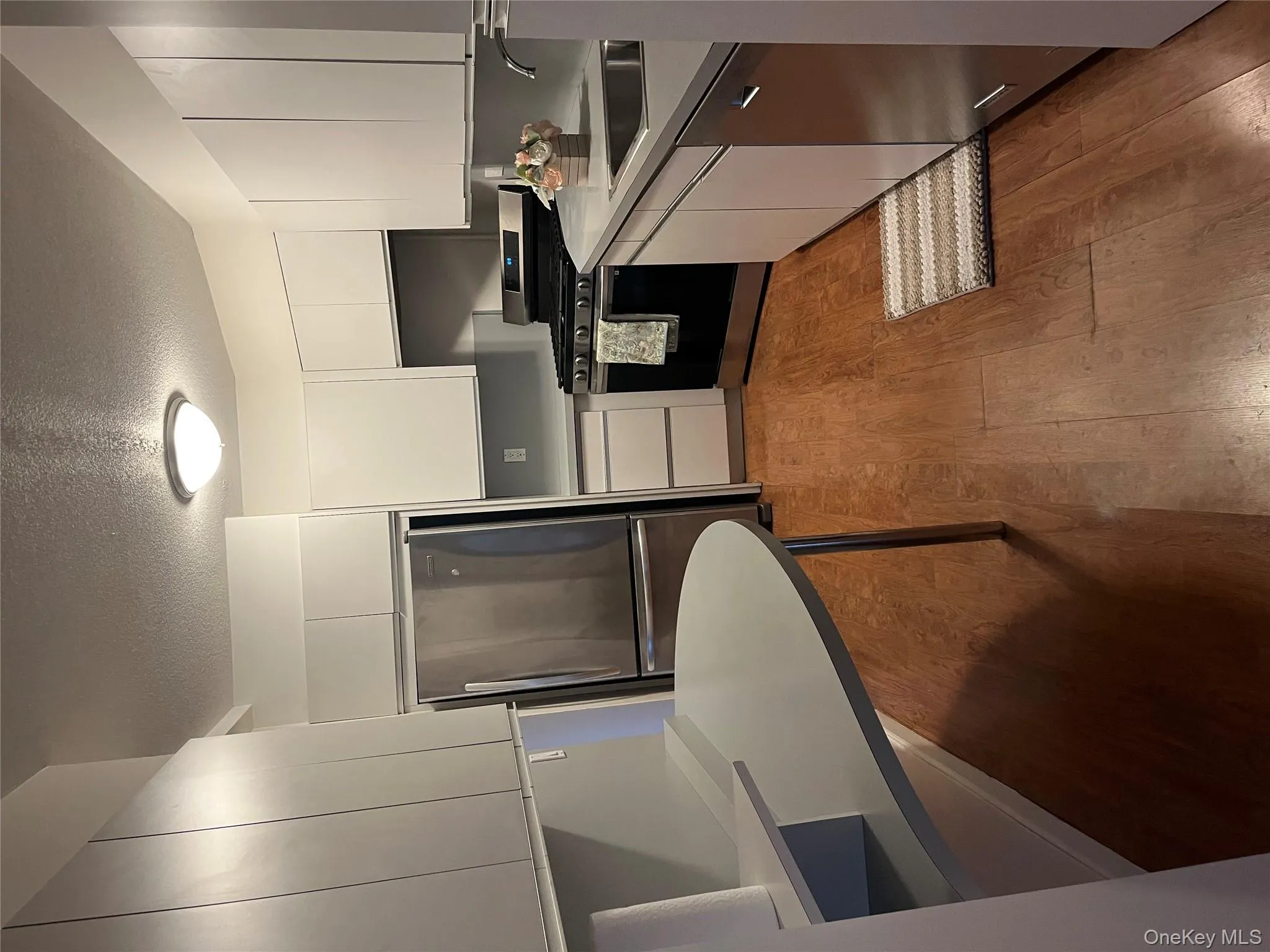 Kitchen featuring range, freestanding refrigerator, light countertops, a textured ceiling, and dishwasher Kitchen featuring range, freestanding refrigerator, light countertops, a textured ceiling, and dishwasher