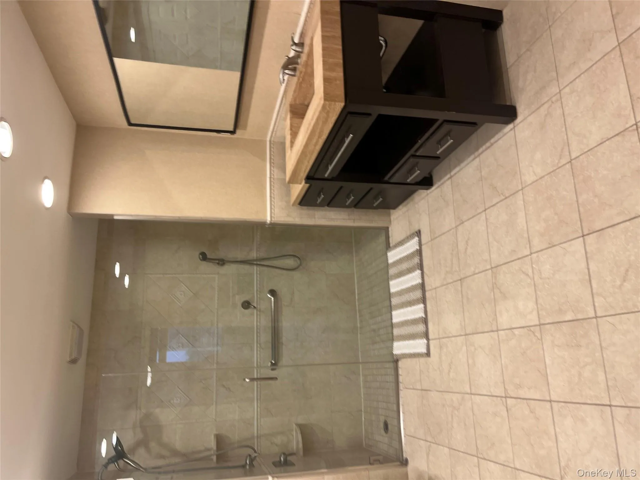 Bathroom with vanity, a shower stall, recessed lighting, and light tile patterned floors Bathroom with vanity, a shower stall, recessed lighting, and light tile patterned floors