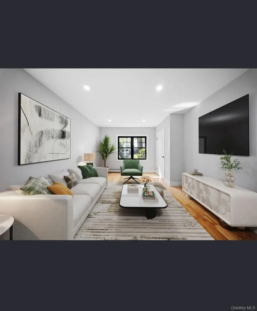 Living room featuring wood finished floors, recessed lighting, and baseboard heating Living room featuring wood finished floors, recessed lighting, and baseboard heating