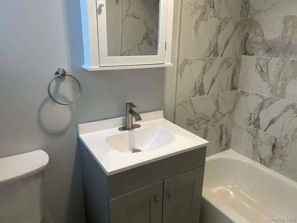 Full bathroom featuring vanity and shower / tub combination Full bathroom featuring vanity and shower / tub combination