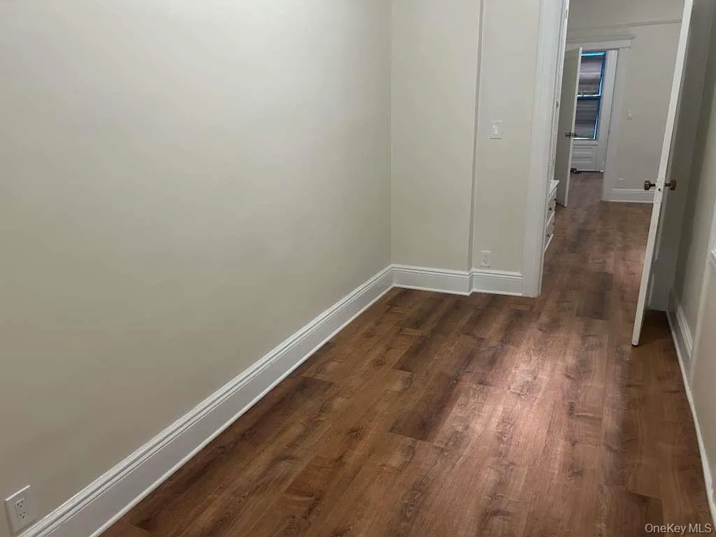 Hall featuring baseboards and dark wood finished floors Hall featuring baseboards and dark wood finished floors