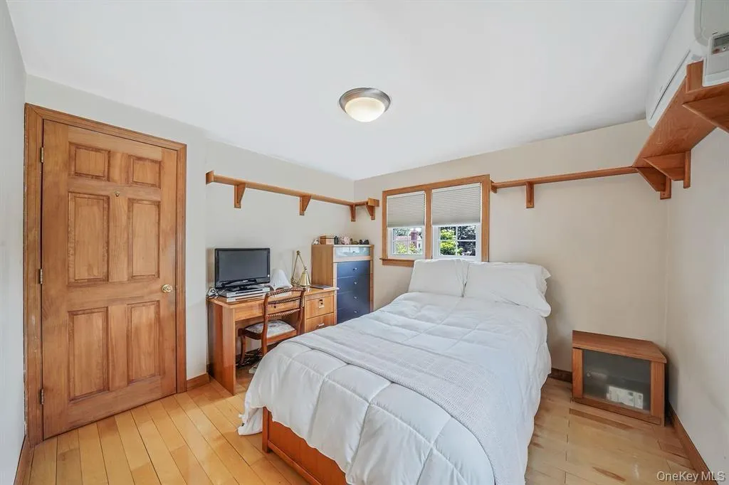 Bedroom with baseboards and light wood-type flooring Bedroom with baseboards and light wood-type flooring
