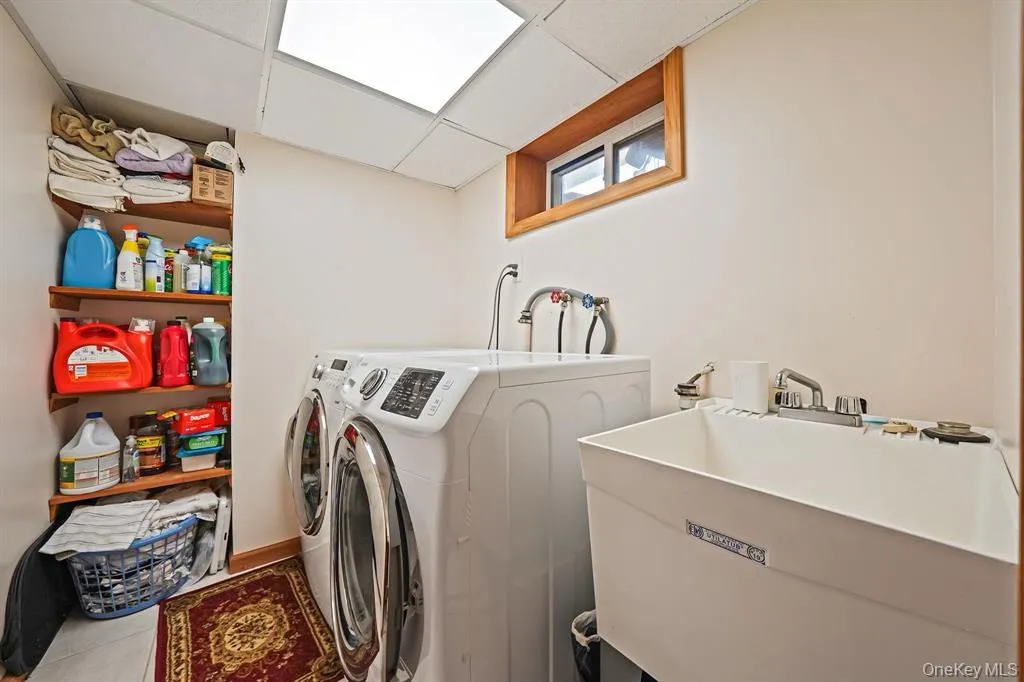 Washroom featuring washer and clothes dryer and a paneled ceiling Washroom featuring washer and clothes dryer and a paneled ceiling