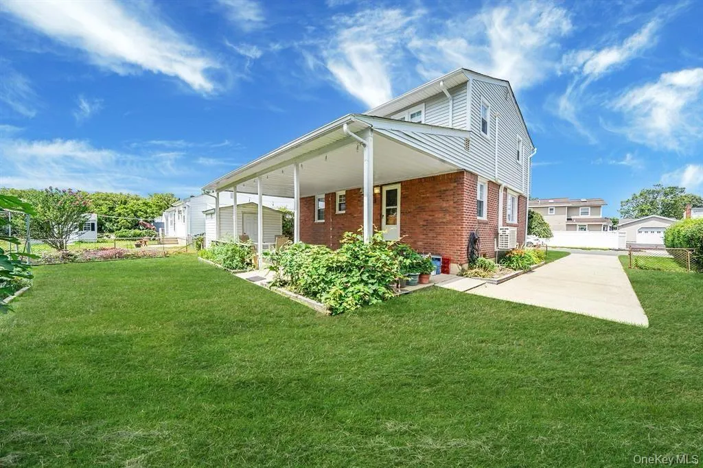 View of side of home with brick siding and a porch View of side of home with brick siding and a porch