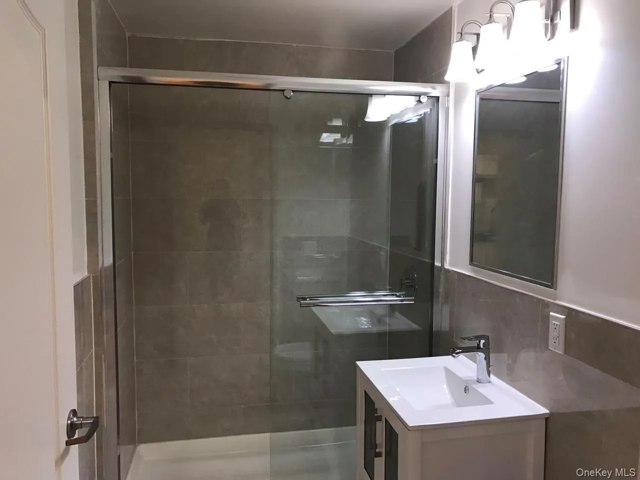Full bathroom with a stall shower and vanity Full bathroom with a stall shower and vanity