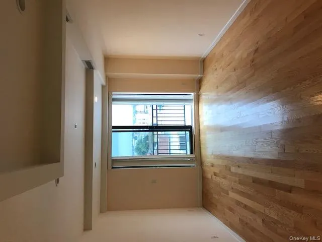 Unfurnished room featuring light wood finished floors, beam ceiling, and recessed lighting Unfurnished room featuring light wood finished floors, beam ceiling, and recessed lighting