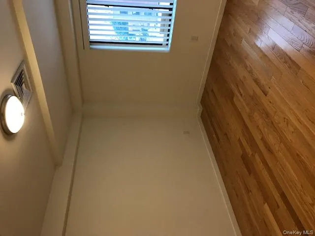 Spare room featuring wood-type flooring and beamed ceiling Spare room featuring wood-type flooring and beamed ceiling