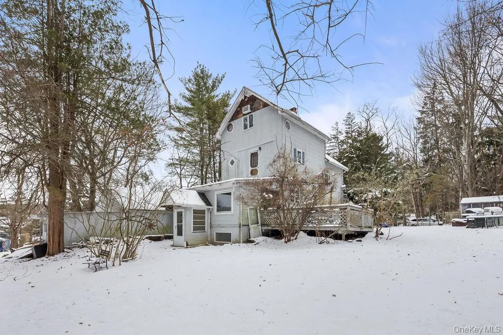 Snow covered property with a deck Snow covered property with a deck