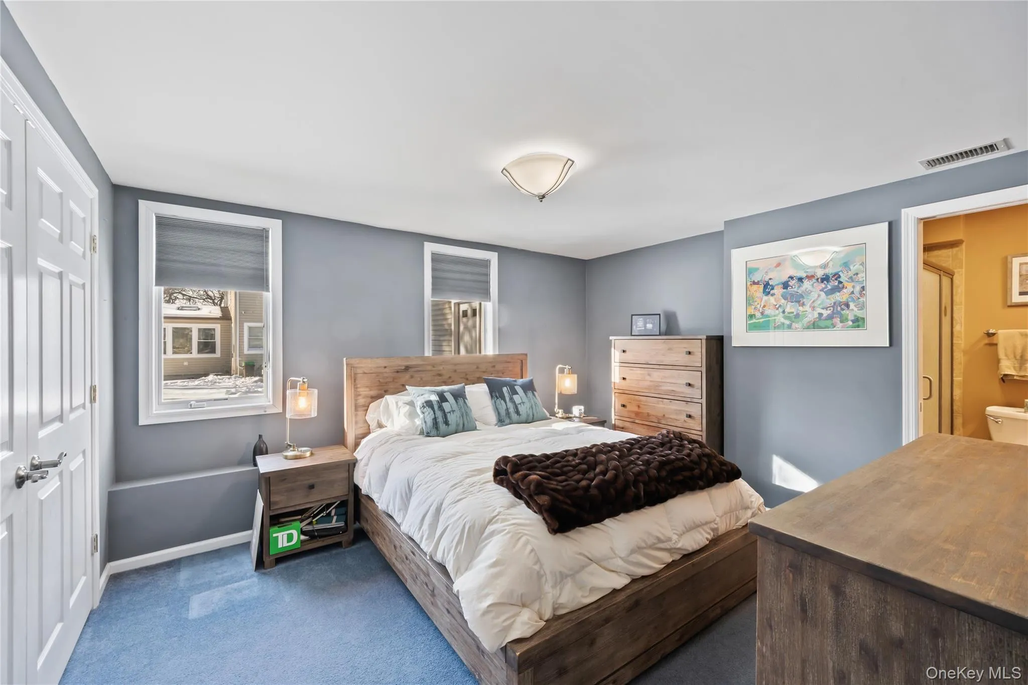 Carpeted bedroom with a closet and baseboards Carpeted bedroom with a closet and baseboards