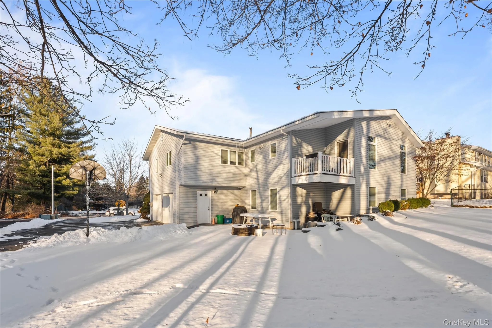 Snow covered property with a balcony Snow covered property with a balcony