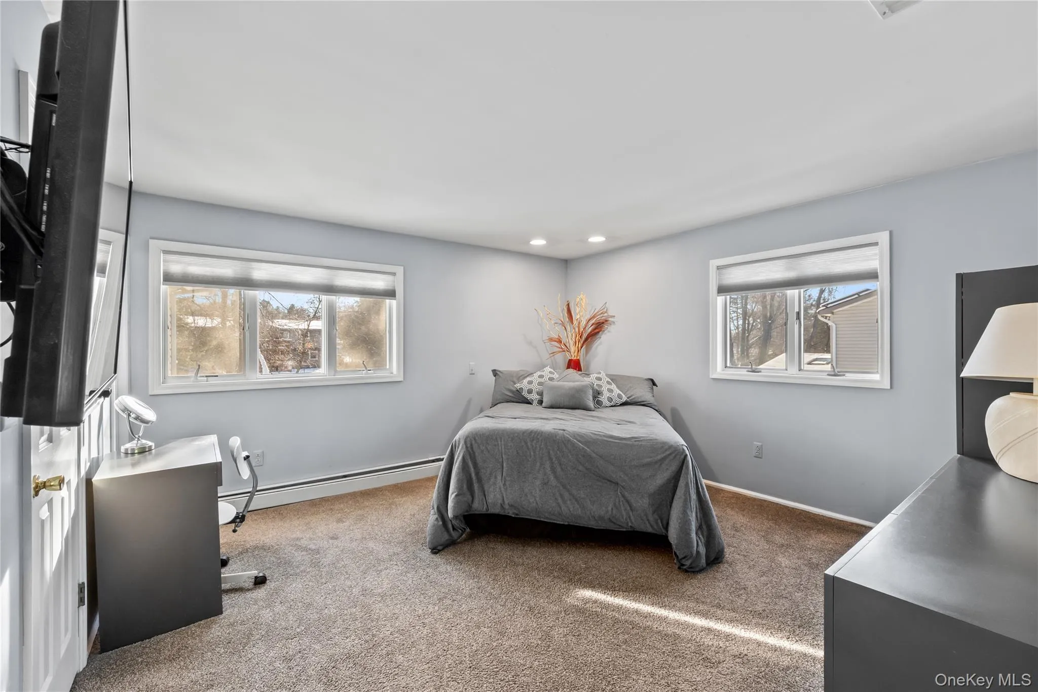 Bedroom with carpet, a baseboard heating unit, and recessed lighting Bedroom with carpet, a baseboard heating unit, and recessed lighting