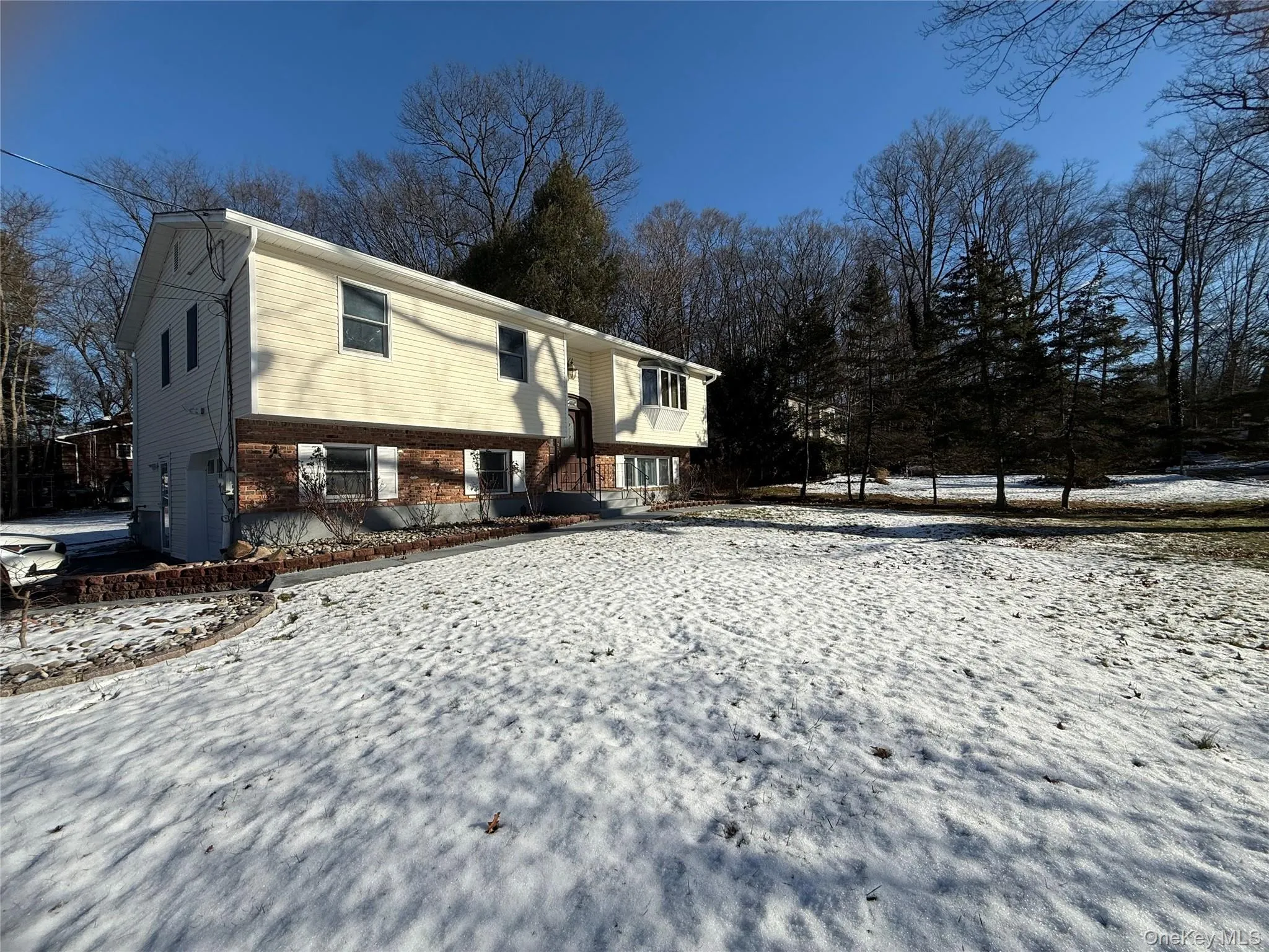 View of snow covered exterior featuring brick siding View of snow covered exterior featuring brick siding