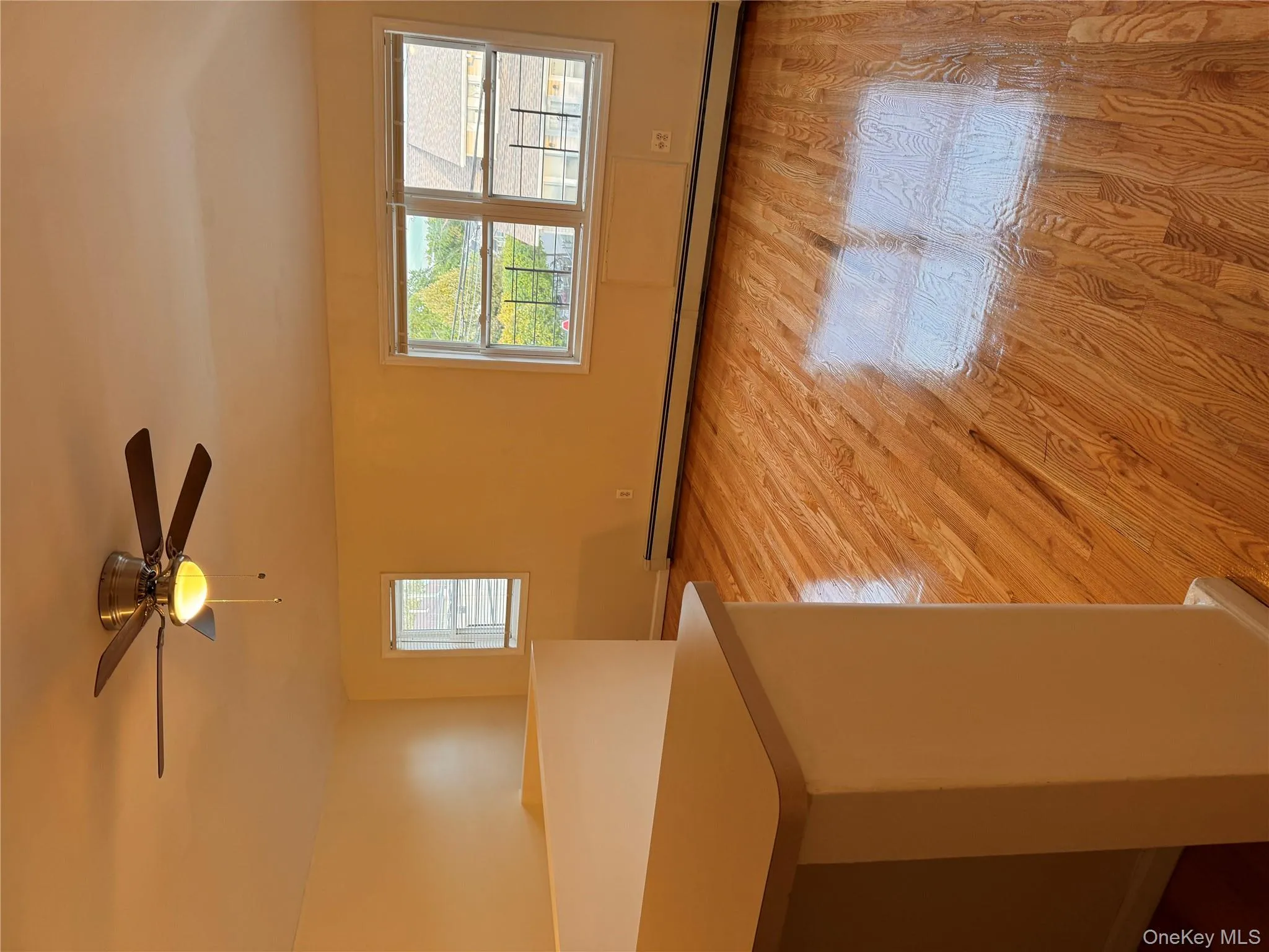 Unfurnished room featuring a baseboard heating unit, light wood-style floors, and a ceiling fan Unfurnished room featuring a baseboard heating unit, light wood-style floors, and a ceiling fan
