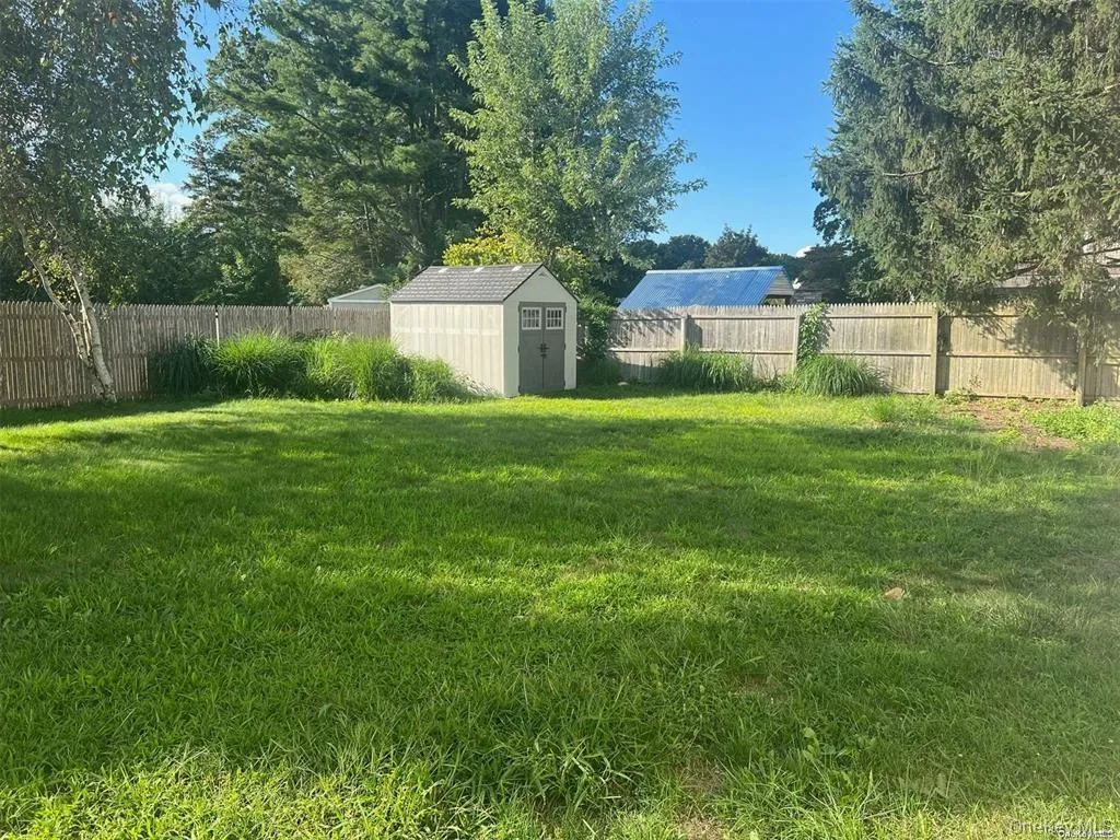 Fenced backyard with a shed Fenced backyard with a shed