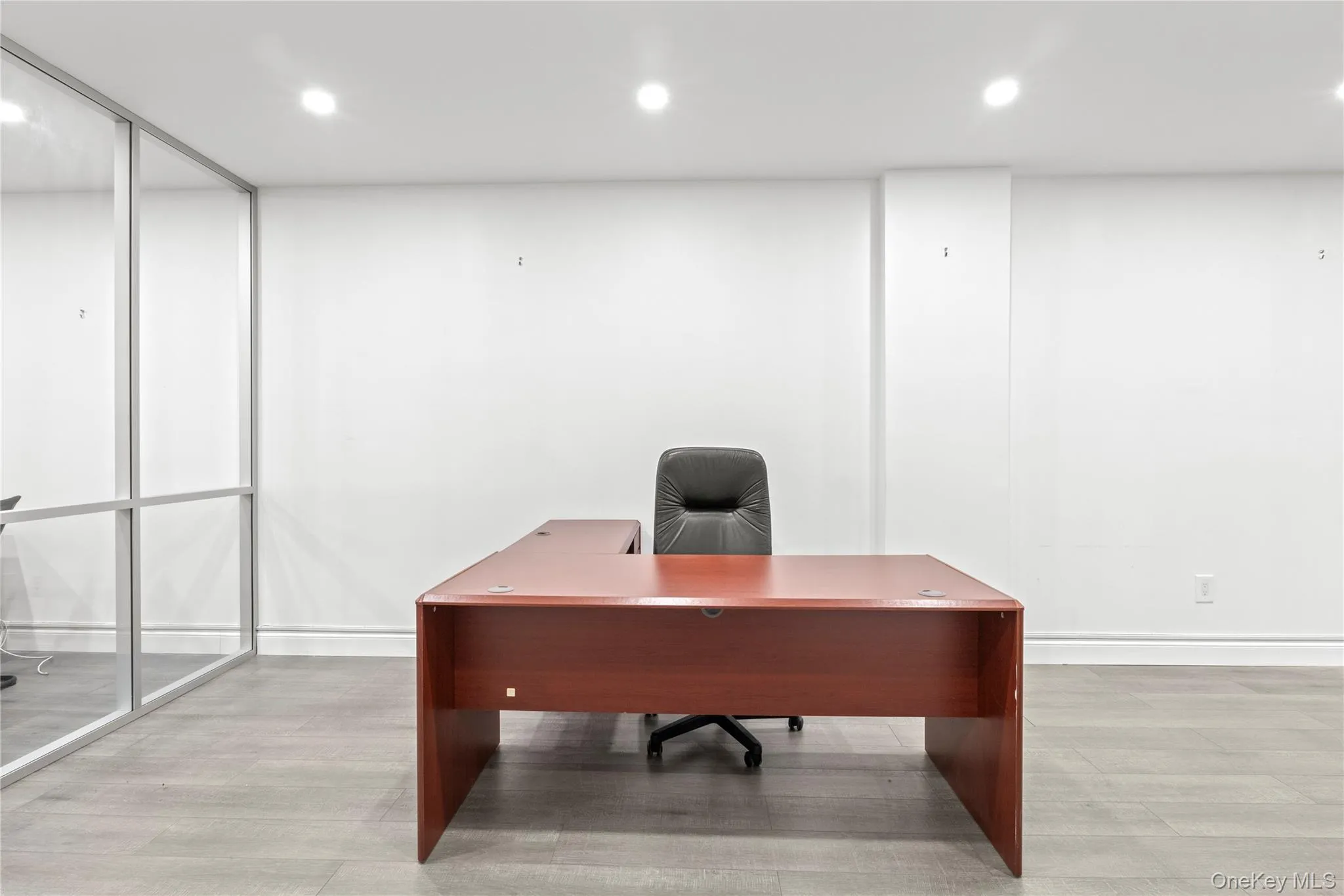Office space with recessed lighting and light wood-style floors Office space with recessed lighting and light wood-style floors