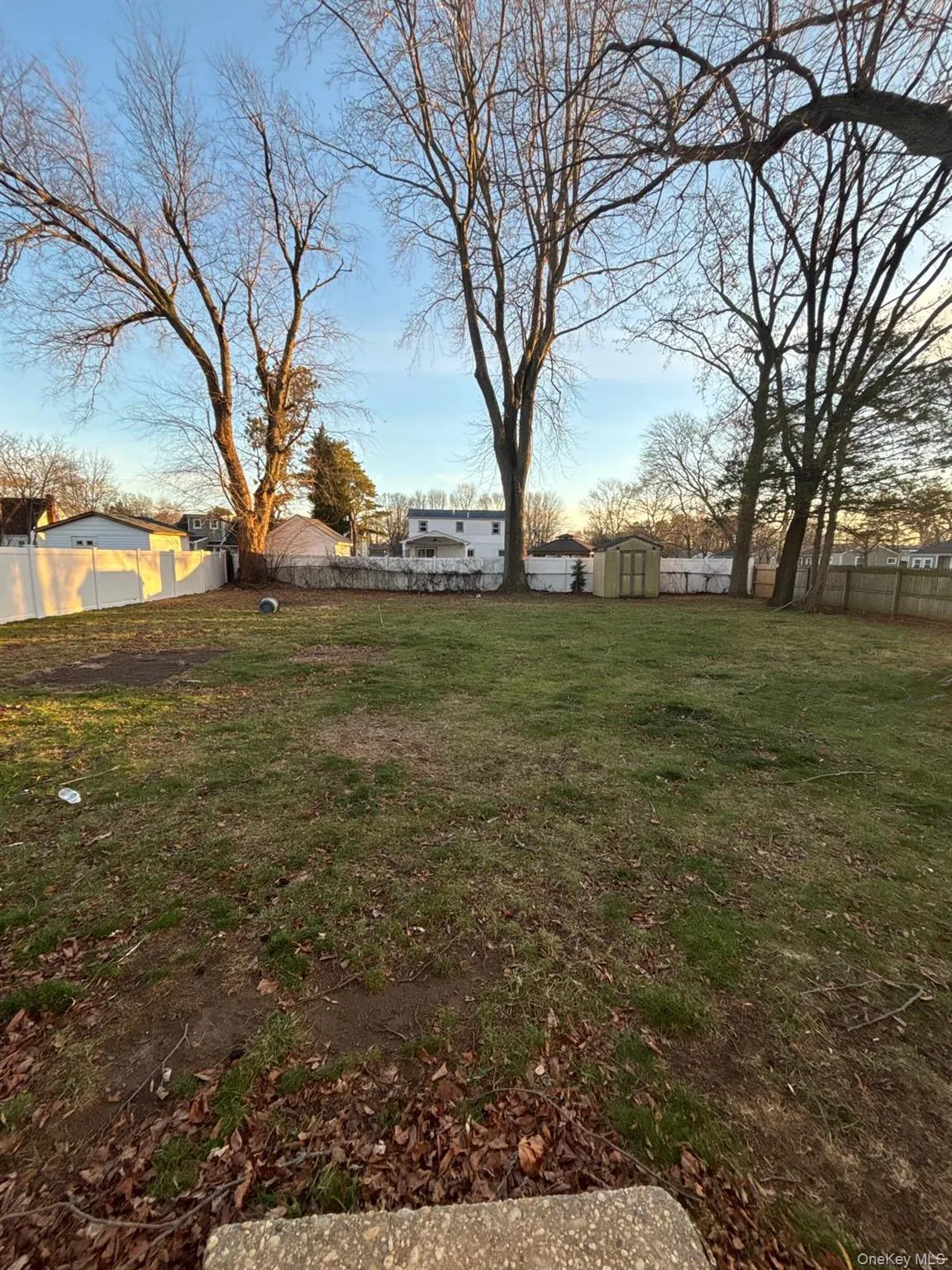 Fenced backyard with a storage unit Fenced backyard with a storage unit