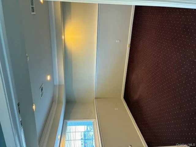 Unfurnished room with dark colored carpet, recessed lighting, and ornamental molding Unfurnished room with dark colored carpet, recessed lighting, and ornamental molding