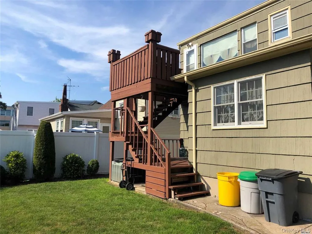 Rear view of house featuring stairs and a wooden deck Rear view of house featuring stairs and a wooden deck