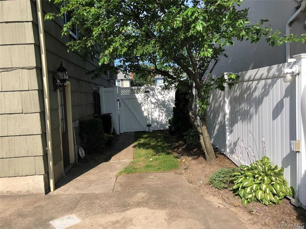 View of yard featuring a gate View of yard featuring a gate