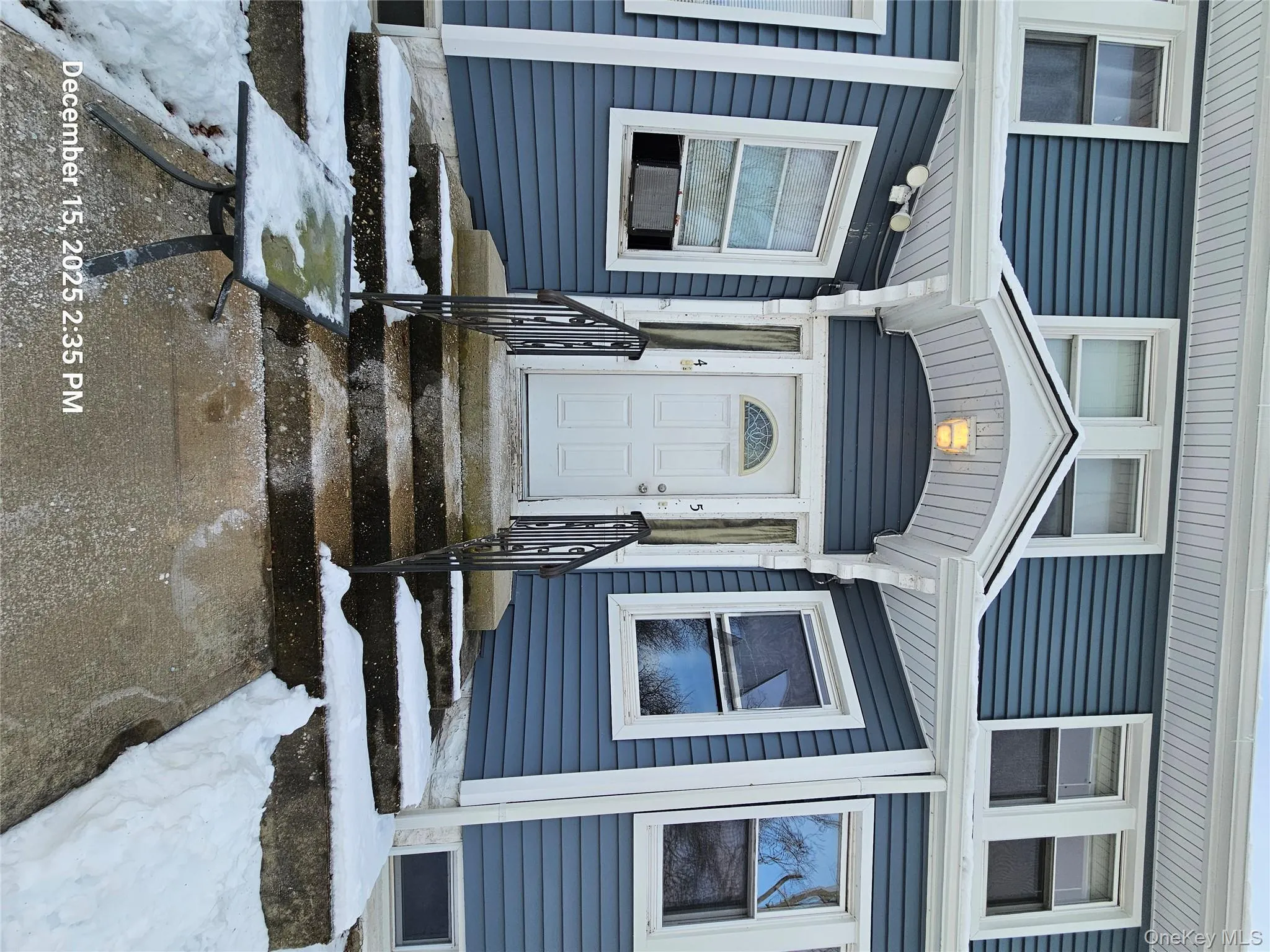 Snow covered property entrance with cooling unit Snow covered property entrance with cooling unit