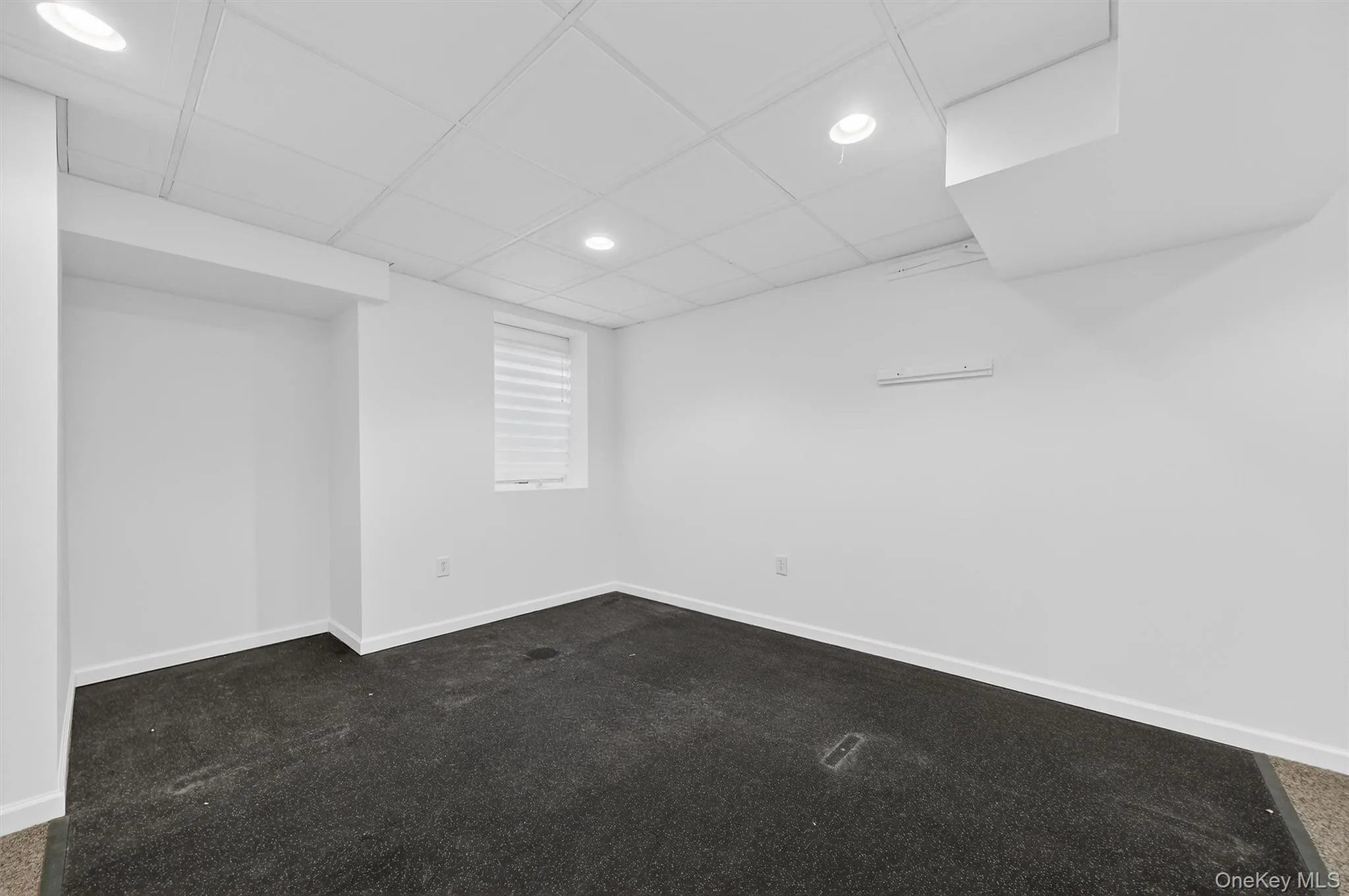 Spare room featuring recessed lighting and dark colored carpet Spare room featuring recessed lighting and dark colored carpet