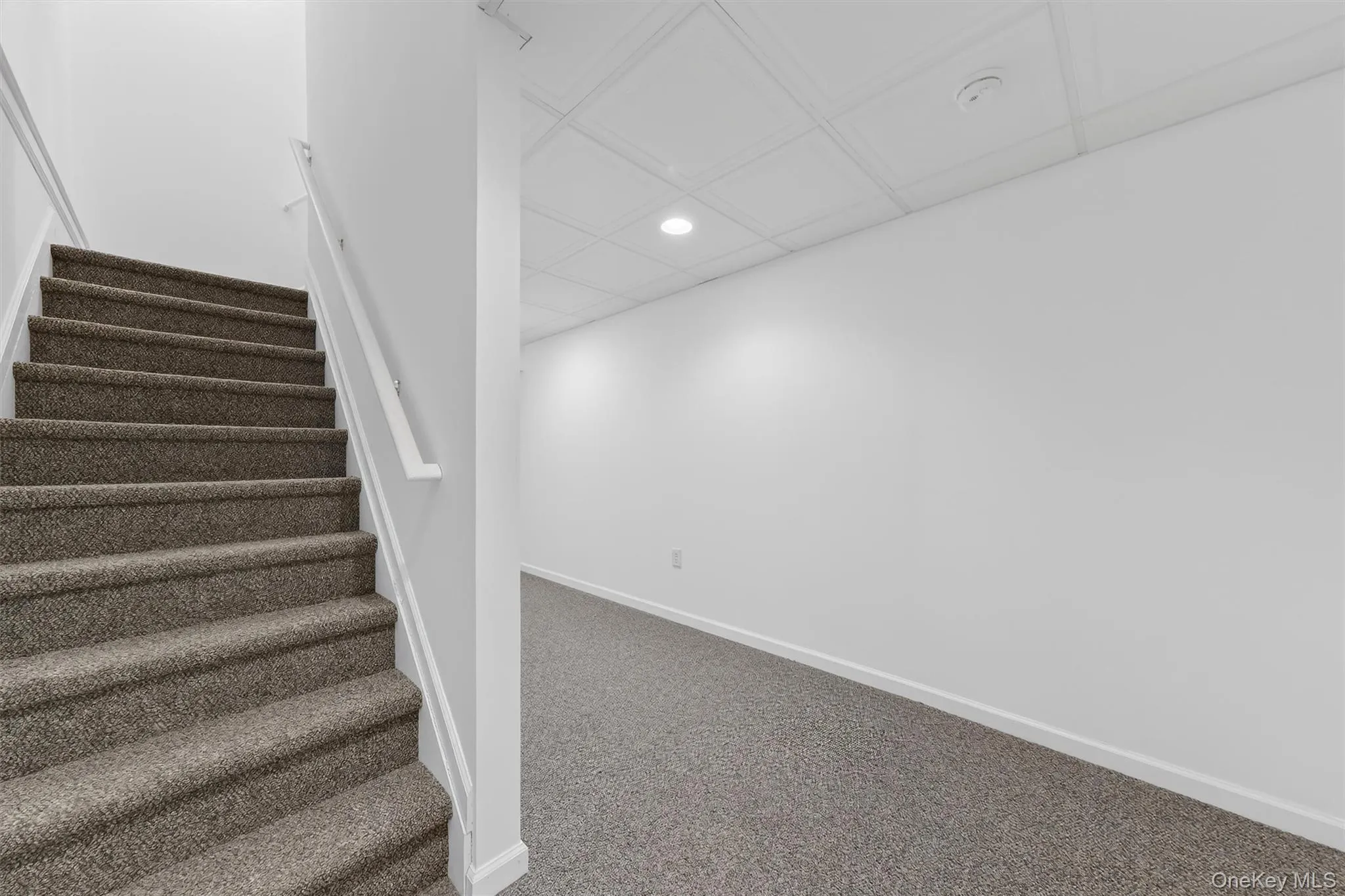 Stairs featuring an ornate ceiling, recessed lighting, and carpet flooring Stairs featuring an ornate ceiling, recessed lighting, and carpet flooring