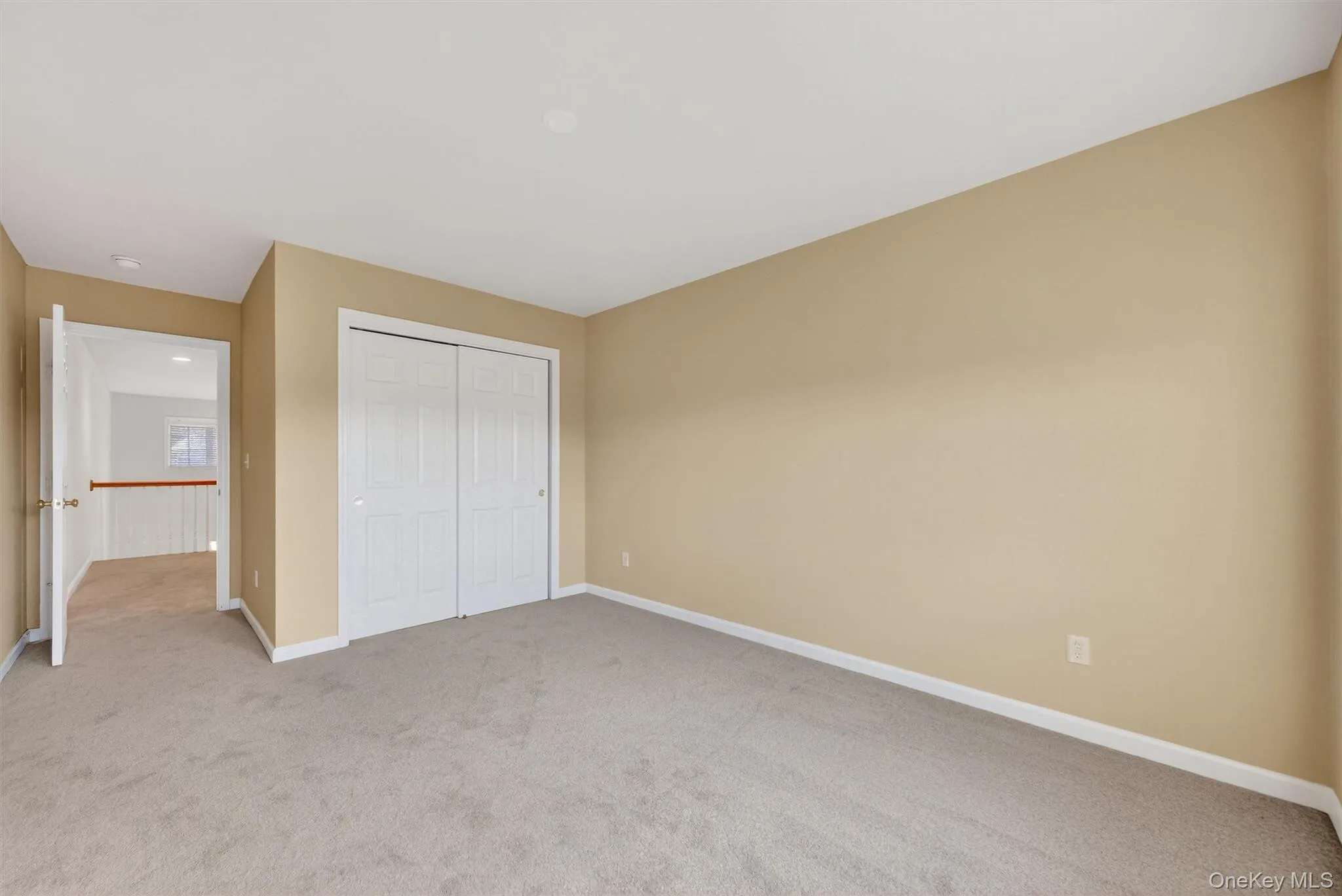 Unfurnished bedroom with light colored carpet and a closet Unfurnished bedroom with light colored carpet and a closet