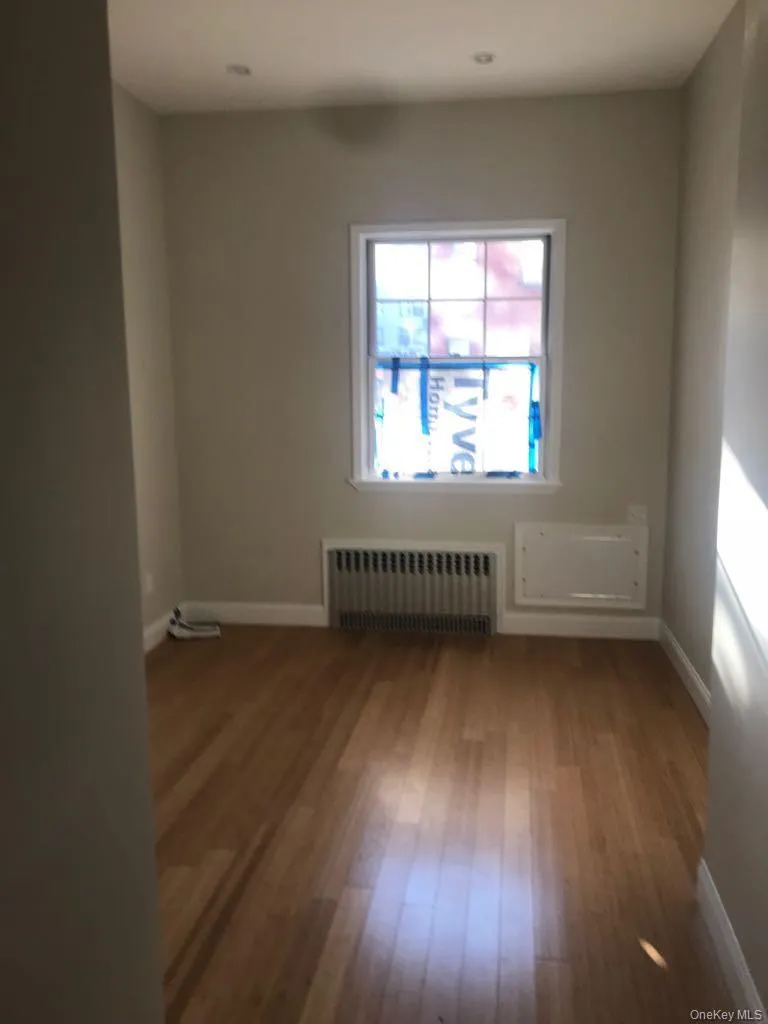 Spare room with radiator and wood-type flooring Spare room with radiator and wood-type flooring