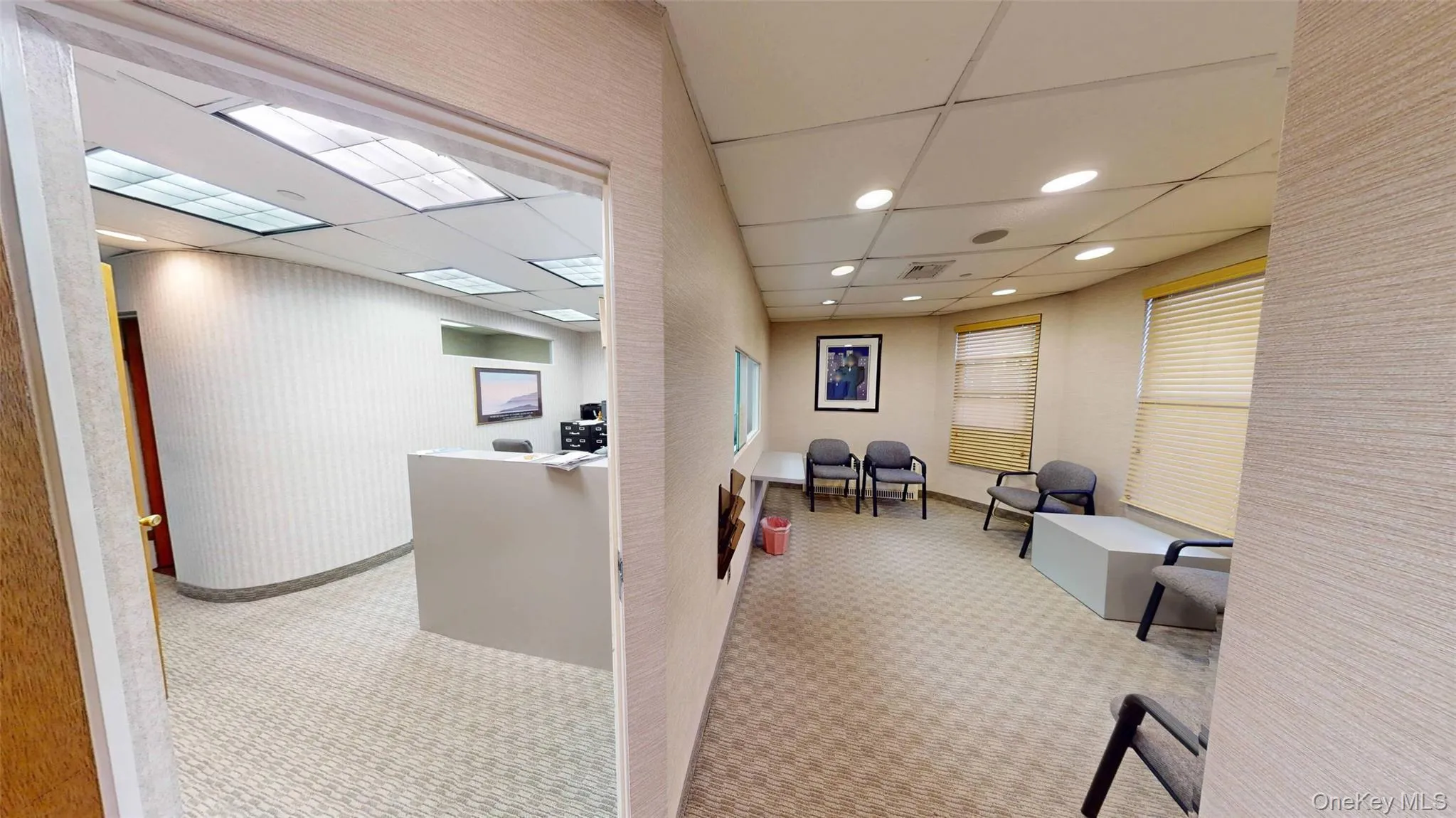 Reception area with a paneled ceiling and recessed lighting Reception area with a paneled ceiling and recessed lighting