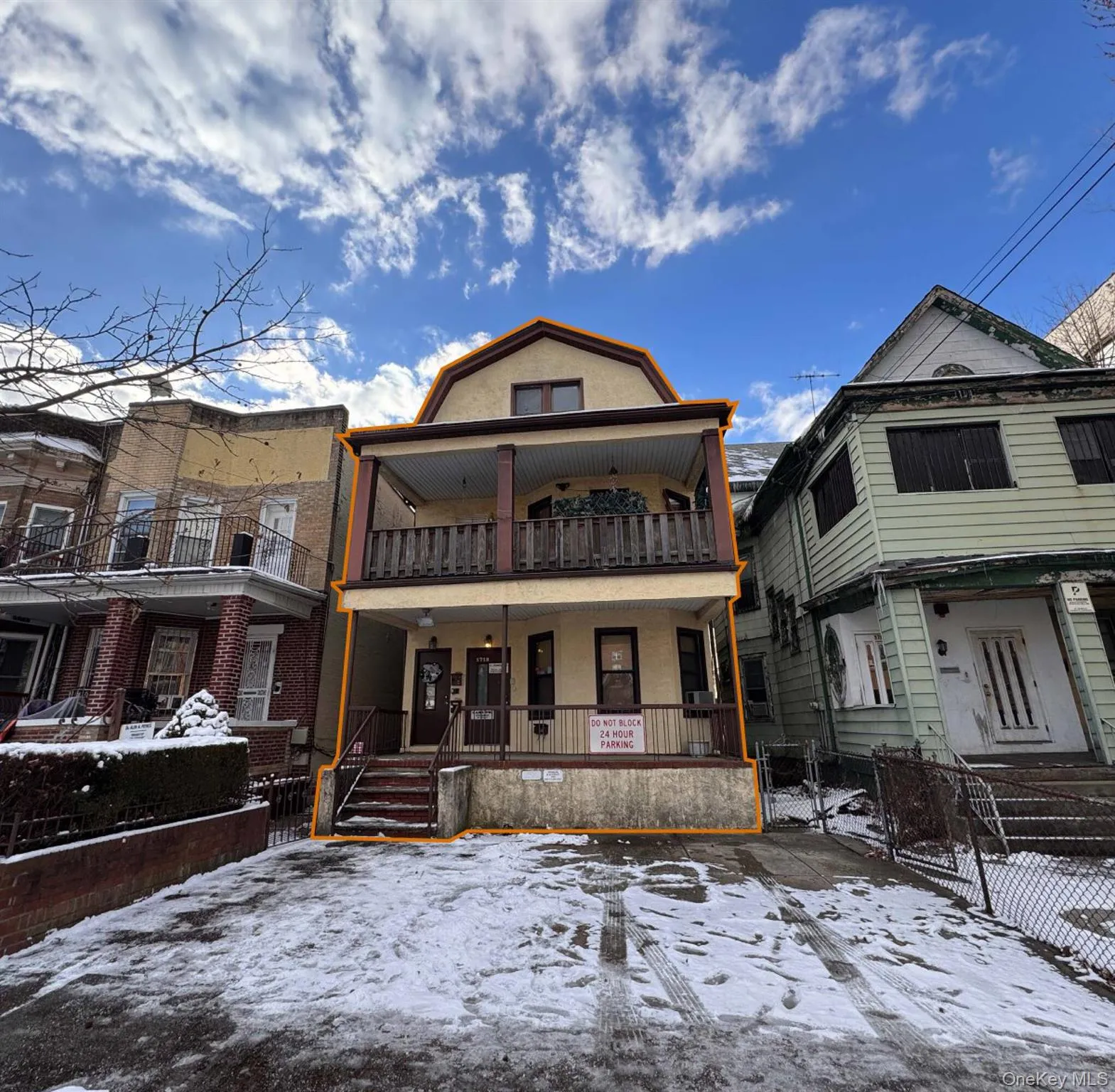 View of front facade with a gate, a fenced front yard, a balcony, and a porch and parking View of front facade with a gate, a fenced front yard, a balcony, and a porch and parking