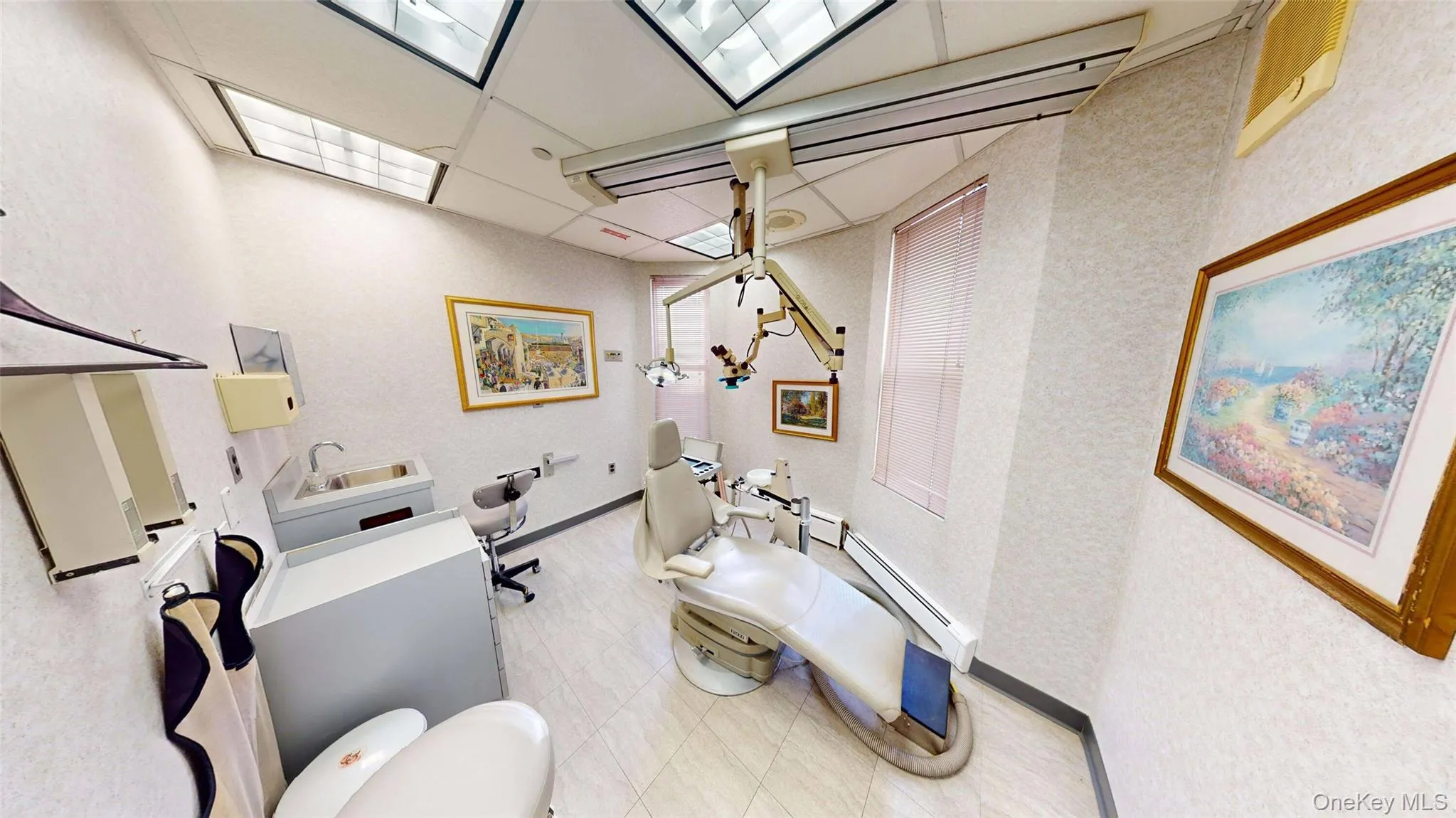 Exam room with dental chair and sink Exam room with dental chair and sink