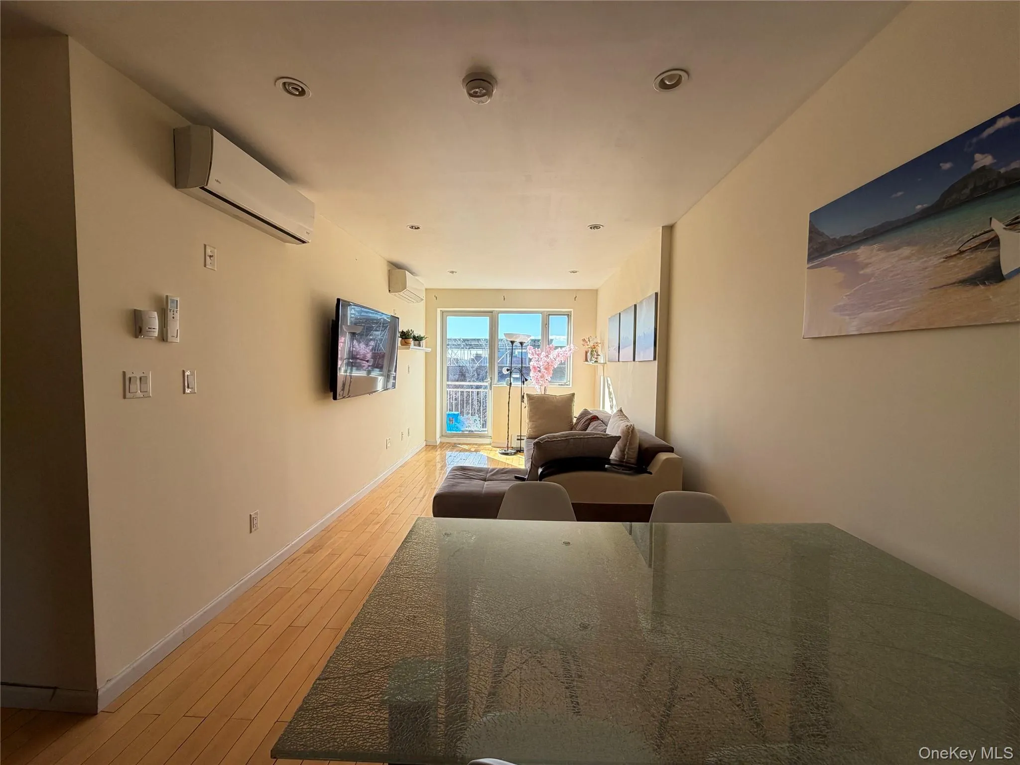Living area featuring light wood-type flooring and recessed lighting Living area featuring light wood-type flooring and recessed lighting