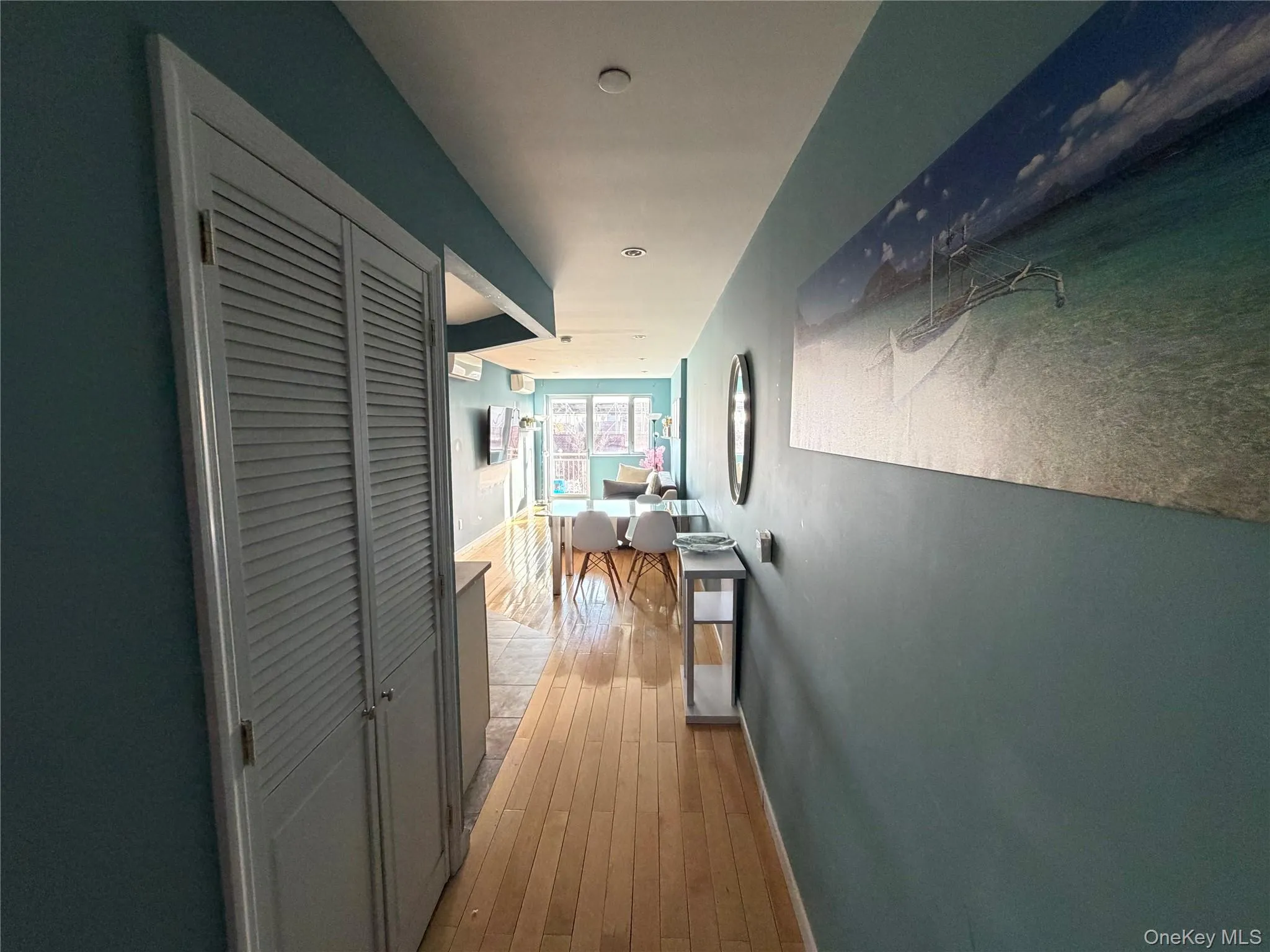 Hallway featuring wood-type flooring and baseboards Hallway featuring wood-type flooring and baseboards