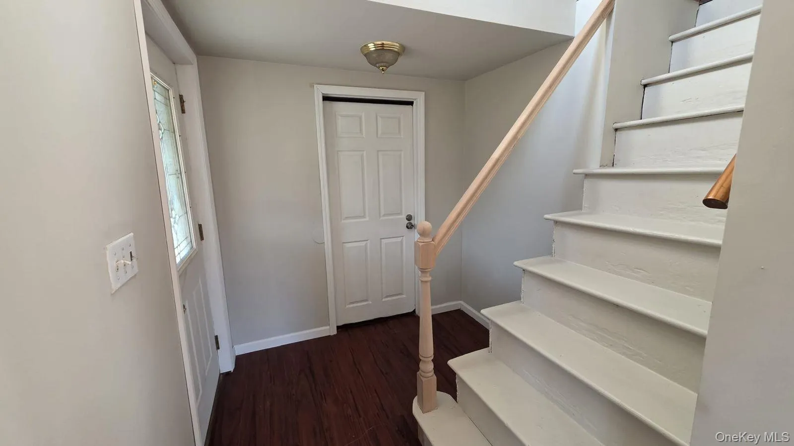 Stairs featuring wood finished floors and baseboards Stairs featuring wood finished floors and baseboards
