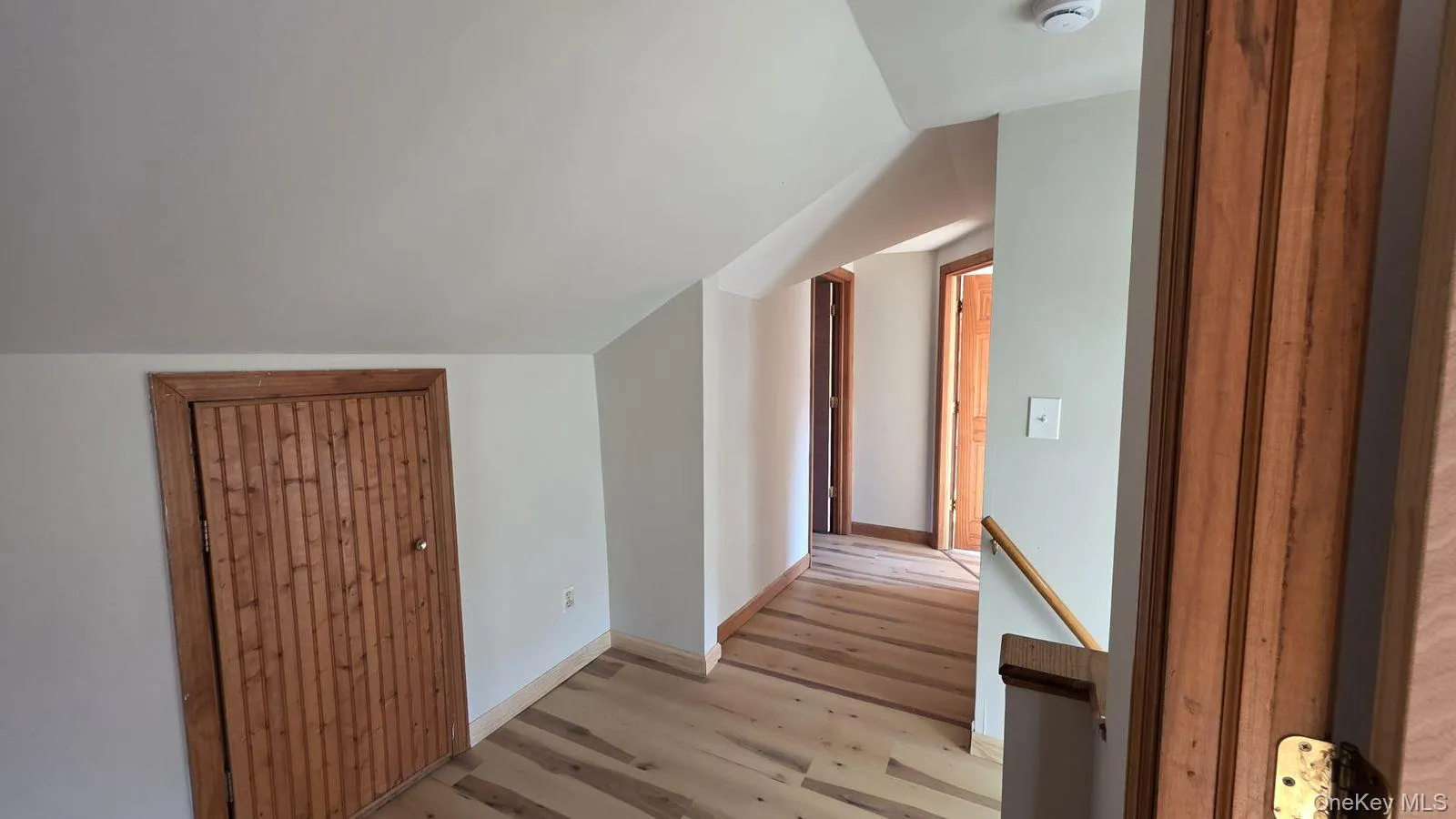 Bonus room featuring lofted ceiling and light wood-type flooring Bonus room featuring lofted ceiling and light wood-type flooring