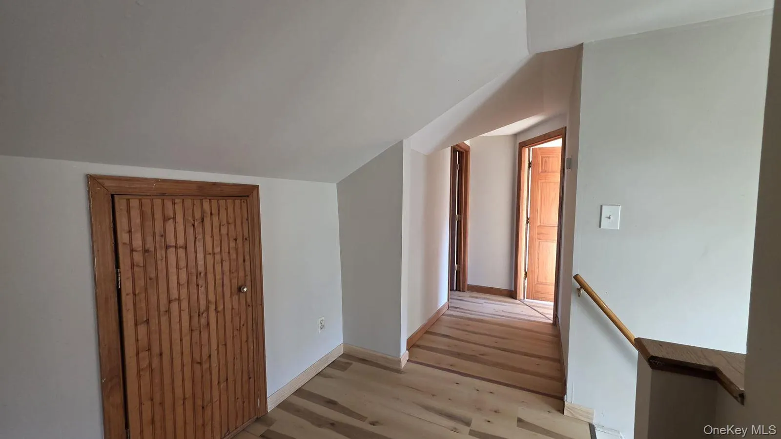 Bonus room featuring vaulted ceiling and wood finished floors Bonus room featuring vaulted ceiling and wood finished floors