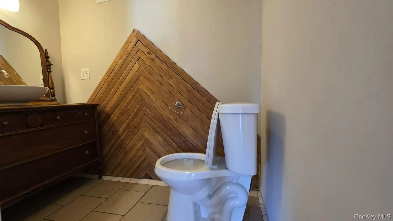 Bathroom with light tile patterned floors and toilet Bathroom with light tile patterned floors and toilet