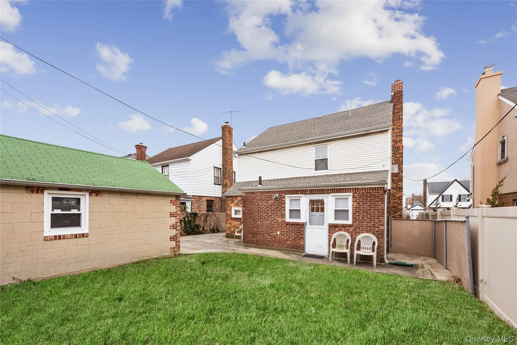 Rear view of property featuring a patio area, and a fully fenced backyard. Rear view of property featuring a patio area, and a fully fenced backyard.