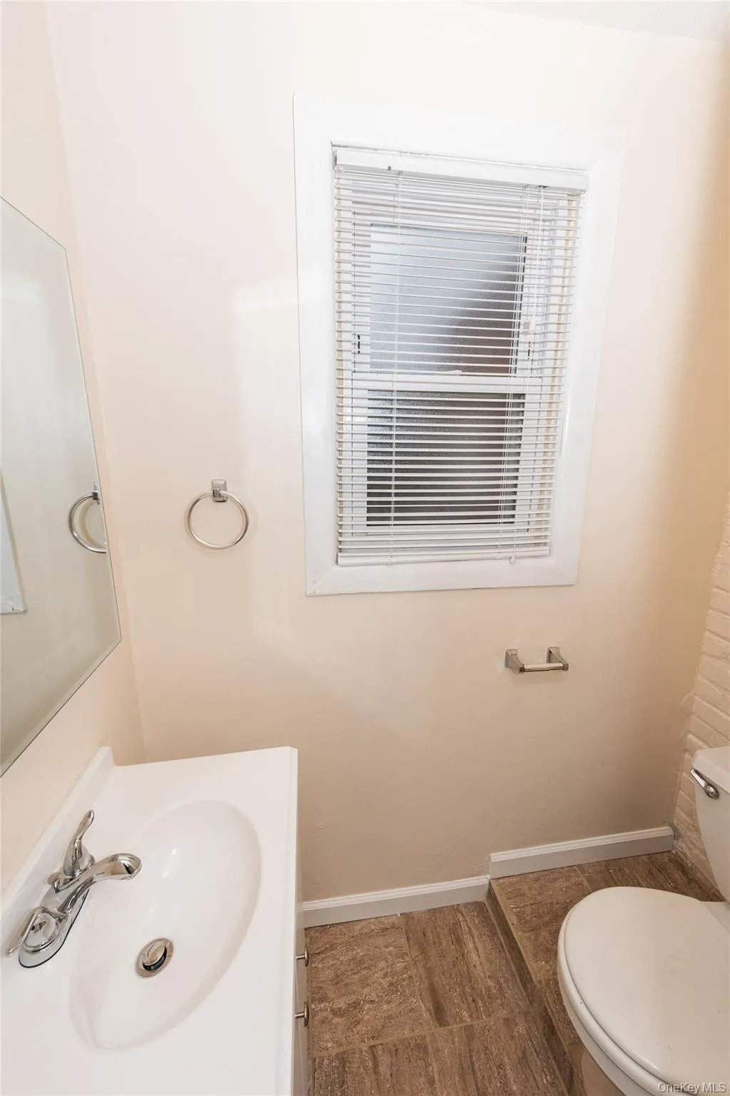 1st floor Half-Bath featuring vanity and toilet. 1st floor Half-Bath featuring vanity and toilet.