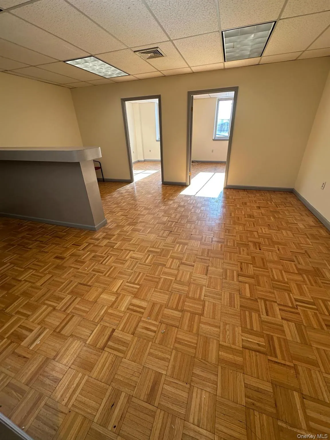 Unfurnished room featuring baseboards and a paneled ceiling Unfurnished room featuring baseboards and a paneled ceiling