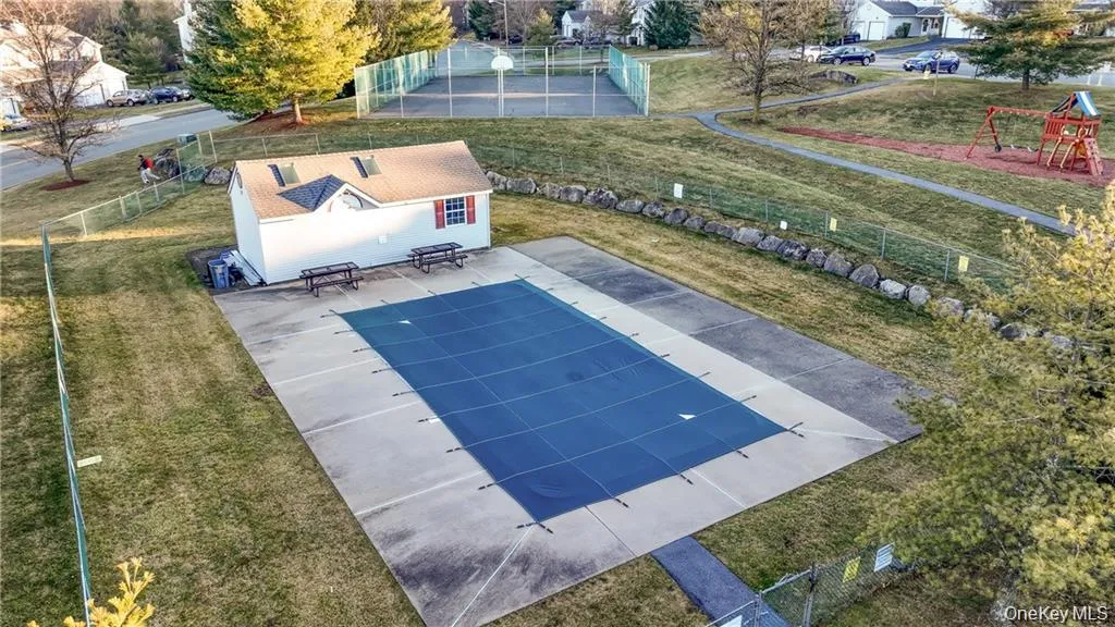 View of swimming pool featuring community basketball court, a patio area, and an outdoor structure View of swimming pool featuring community basketball court, a patio area, and an outdoor structure