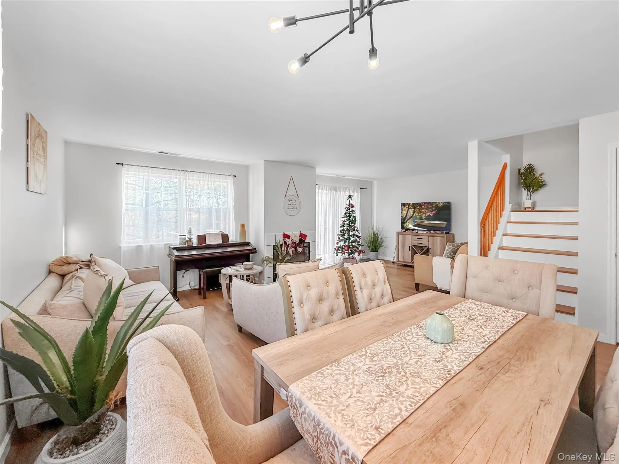 Dining room with stairs and wood finished floors Dining room with stairs and wood finished floors