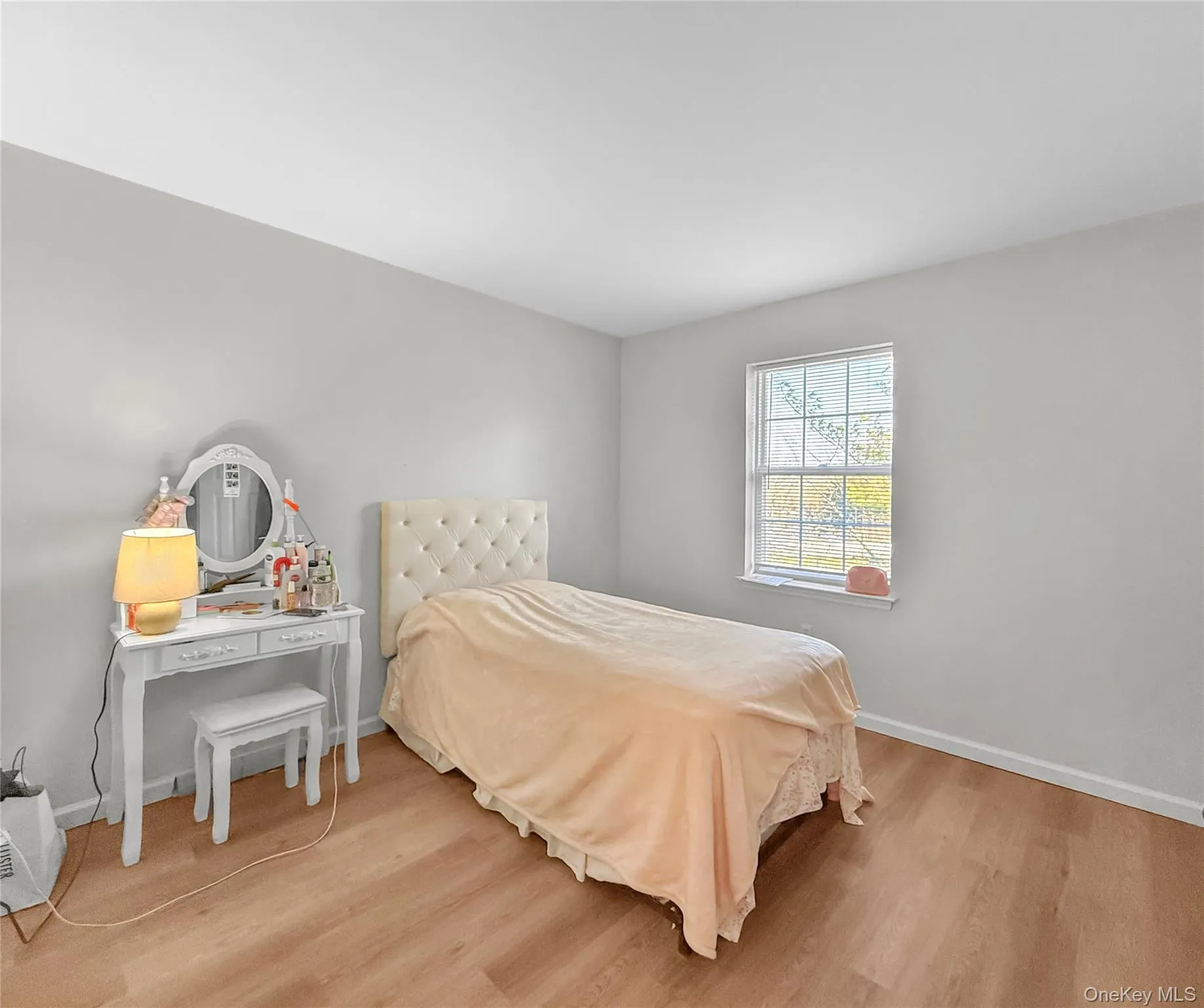 Bedroom featuring light wood-style flooring and baseboards Bedroom featuring light wood-style flooring and baseboards