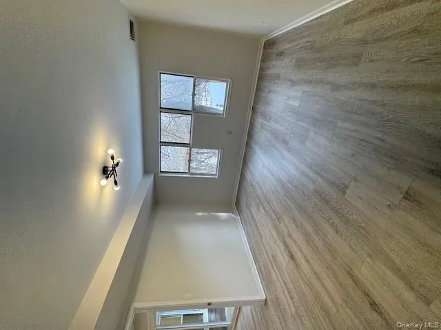 Spare room featuring a textured ceiling and light wood-type flooring Spare room featuring a textured ceiling and light wood-type flooring