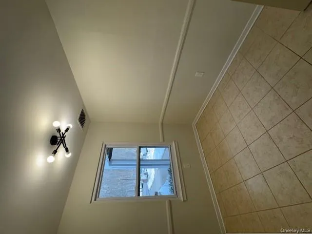 Empty room featuring light tile patterned floors Empty room featuring light tile patterned floors