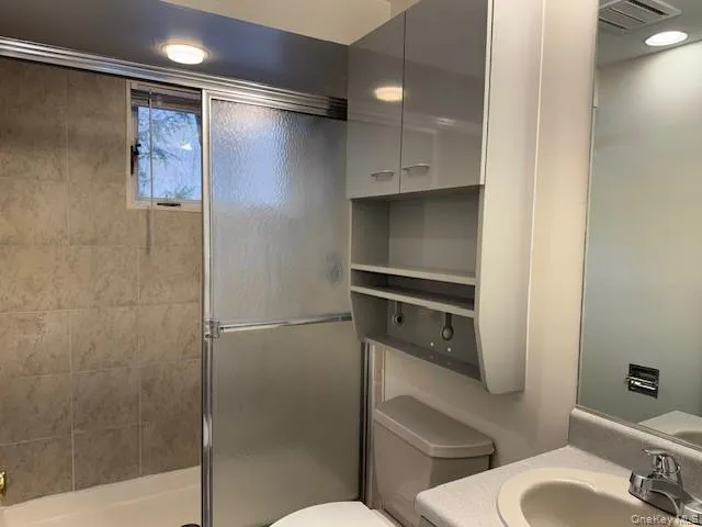 Full bath featuring vanity, a shower stall, and recessed lighting Full bath featuring vanity, a shower stall, and recessed lighting