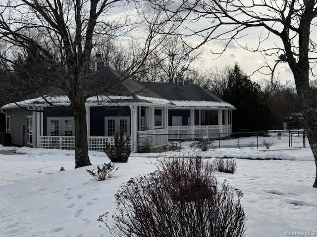 View of front facade with a porch, french doors, and a chimney View of front facade with a porch, french doors, and a chimney