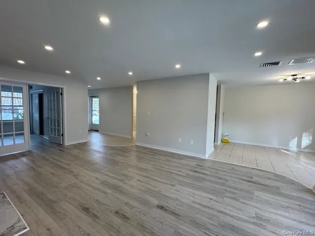 Empty room with light wood-type flooring and recessed lighting Empty room with light wood-type flooring and recessed lighting