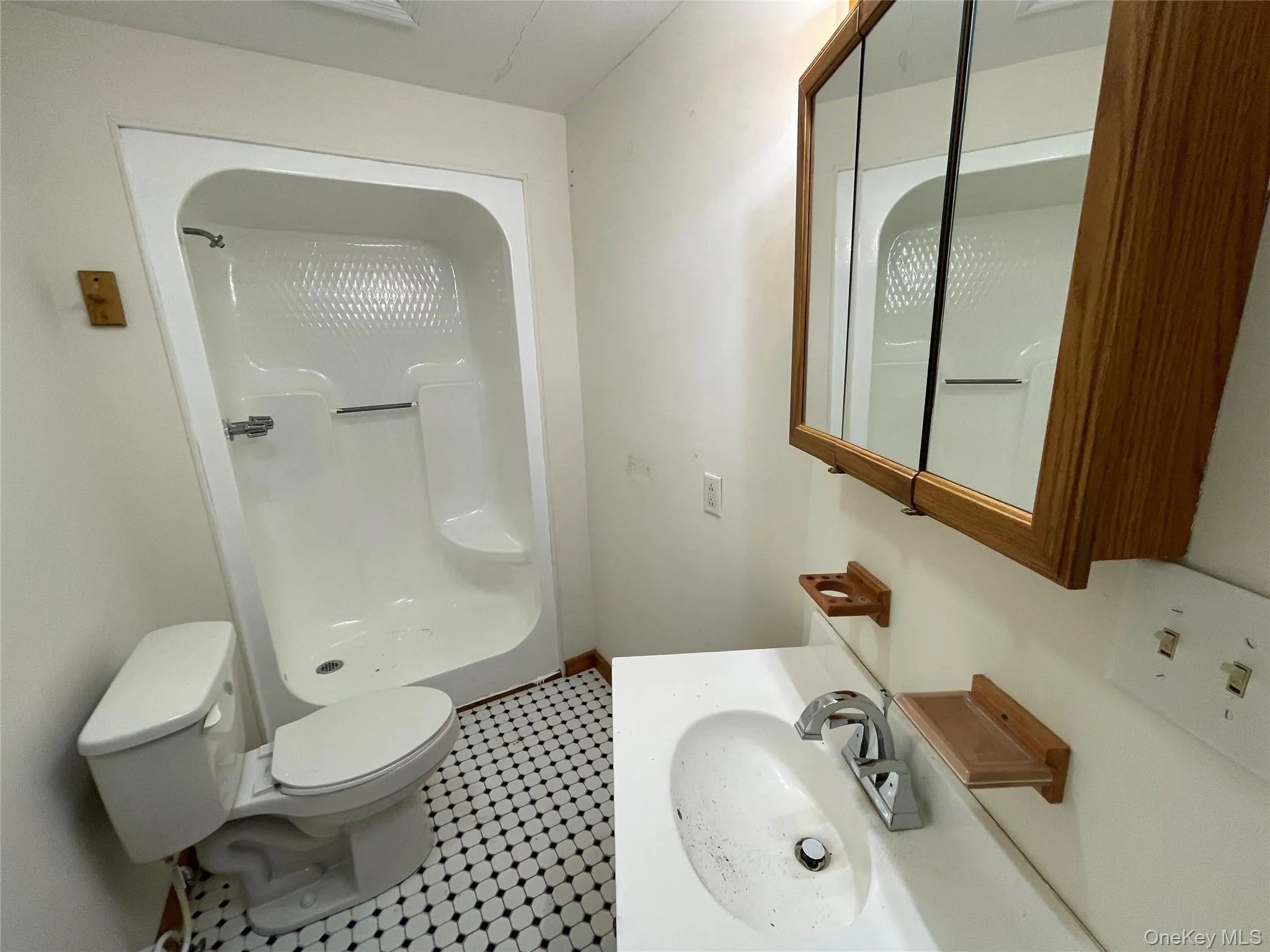 Full bath with a shower, vanity, and tile patterned floors Full bath with a shower, vanity, and tile patterned floors