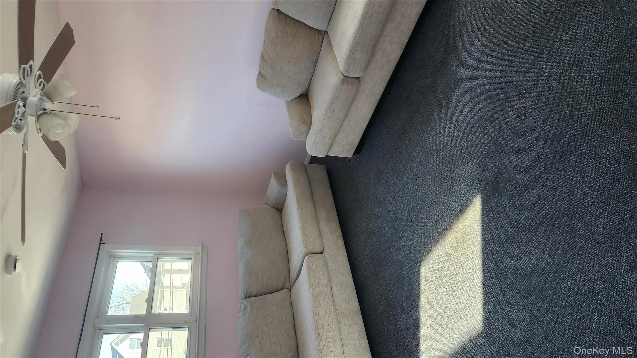 Carpeted living area featuring ceiling fan Carpeted living area featuring ceiling fan